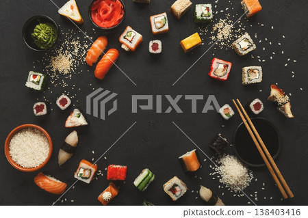 Sushi and rolls background, frame on black, top view. Colorful japanese restaurant food set, copy space Sushi and rolls background, frame on black, top view. Colorful japanese restaurant food set, copy space 138403416