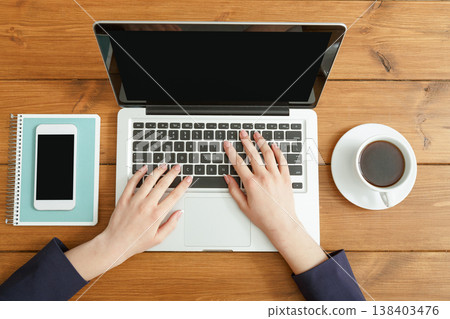 Female using laptop. Freelancer working with portable computer in coffee shop, top view, close up 138403476