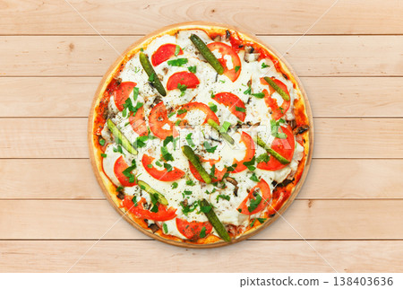 Delicious pizza with mushrooms and asparagus - thin pastry crust at wooden round desk at wood background. Italian food. Top view 138403636