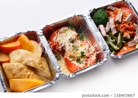 Healthy food in lunch boxes on white background. Eating right concept. Fresh diet daily meals delivery. Vegetables, meat and fruits on wood 138403667