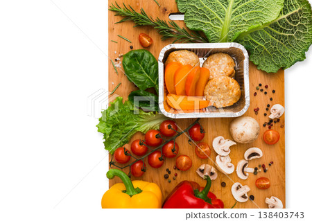 Healthy vegetarian food delivery background. Fresh organic vegetables and lunch box isolated on white. Healthy vegetarian food delivery background. Fresh organic vegetables and lunch box isolated on white. 138403743