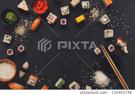 Sushi and rolls background, frame on black, top view, copy space. Colorful japanese restaurant food set Sushi and rolls background, frame on black, top view, copy space. Colorful japanese restaurant food set 138403746