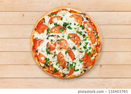 Delicious pizza with mushrooms, tomatoes and chicken meat - thin pastry crust at wooden round desk and wood background. Italian food. Top view 138403765