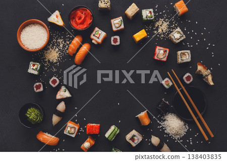 Sushi and rolls background, frame on black, top view, copy space. Colorful japanese restaurant food set Sushi and rolls background, frame on black, top view, copy space. Colorful japanese restaurant food set 138403835