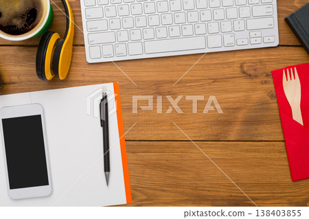 Workplace background with office supplies on wooden desk, flat lay, top view. Copy space on notebook and phone Workplace background with office supplies on wooden desk, flat lay, top view. Copy space on notebook and phone 138403855