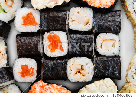 Japanese food background - sushi maki gunkan salmon roll isolated at white background, above view. Closeup detail of sushi rolls. Sushi set macro close up. Japanese food background - sushi maki gunkan salmon roll isolated at white background, above view. Closeup detail of sushi rolls. Sushi set macro close up. 138403905