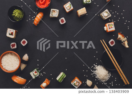 Sushi and rolls background, frame on black, top view. Colorful japanese restaurant food set 138403909