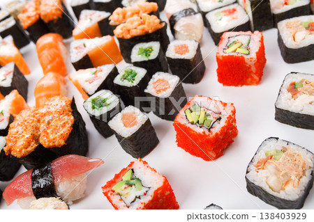 Japanese food restaurant delivery closeup - sushi and rolls platter set at white background Japanese food restaurant delivery closeup - sushi and rolls platter set at white background 138403929