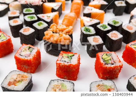 Traditional japanese food delivery. Closeup of sushi set with rolls, gunkan and nigiri at white background 138403944