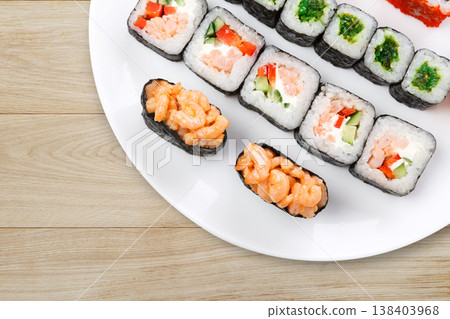 Japanese restaurant background, rolls and sushi platter closeup. Set crop, top view on rustic wood Japanese restaurant background, rolls and sushi platter closeup. Set crop, top view on rustic wood 138403968