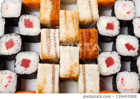 Sushi and rolls closeup background, japanese restaurant delivery. Salmon, unagi, california and other healthy meals Sushi and rolls closeup background, japanese restaurant delivery. Salmon, unagi, california and other healthy meals 138403988