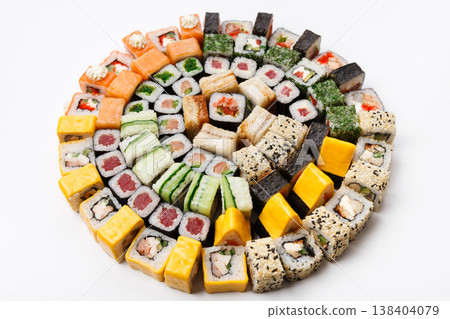 Sushi big party platter isolated on white background. Japanese food restaurant delivery - maki, unagi and california rolls set placed in circle Sushi big party platter isolated on white background. Japanese food restaurant delivery - maki, unagi and california rolls set placed in circle 138404079