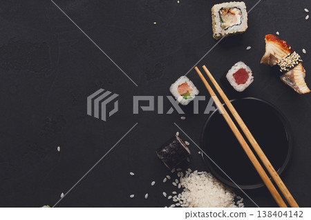 Sushi and rolls background, copy space on black, top view. Japanese restaurant food set 138404142