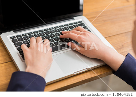 Business woman working in office, typing on laptop, close-up, shallow depth of field Business woman working in office, typing on laptop, close-up, shallow depth of field 138404191