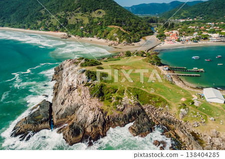 Rocky island and ocean with waves in Brazil. Drone shot of Matadeiro Beach and Ponta das Campanhas 138404285