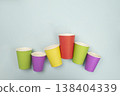 Multicolored takeaway coffee cups arranged on blue background, top view image for branding or product promotion 138404339