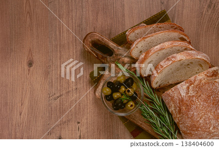 sliced ciabatta , on a chopping board, with rosemary and olives, Italian bread, close-up, Italian cuisine, breakfast, no people, sliced ciabatta , on a chopping board, with rosemary and olives, Italian bread, close-up, Italian cuisine, breakfast, no people, 138404600