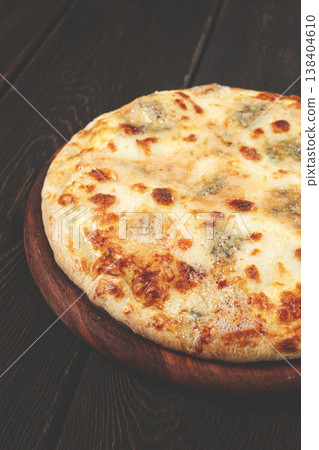 Freshly baked cheese pizza, with a golden crust and bubbling melted cheese, white pizza, on a wooden board, homemade, no people, 138404610