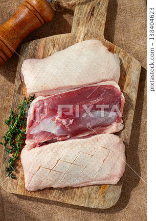 Fresh raw duck breast, on a wooden chopping board, top view, no people, 138404623