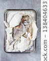 Baked Dorado fish, in salt on a baking sheet, top view, homemade, no people. 138404633