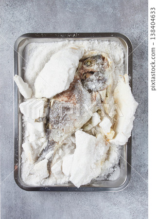 Baked Dorado fish, in salt on a baking sheet, top view, homemade, no people. Baked Dorado fish, in salt on a baking sheet, top view, homemade, no people. 138404633
