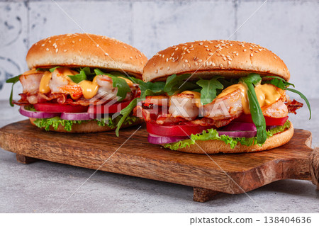 Shrimp burgers with fresh ingredients are served on a wooden board in a bright kitchen, Shrimp burgers with fresh ingredients are served on a wooden board in a bright kitchen, 138404636
