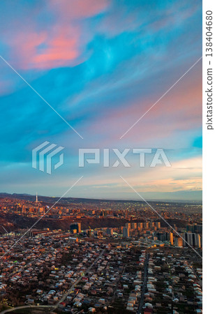 { description: "Dusk over urban landscape with colorful clouds { description: "Dusk over urban landscape with colorful clouds 138404680
