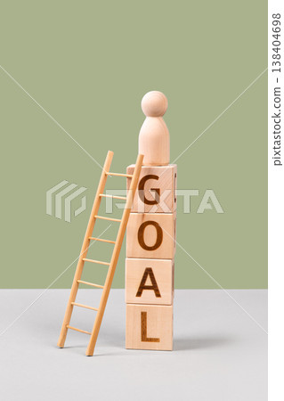 Wooden cubes with the words goal and wooden ladders are a symbol of success, business progress, strategic development of a company, startup. Business concept Wooden cubes with the words goal and wooden ladders are a symbol of success, business progress, strategic development of a company, startup. Business concept 138404698