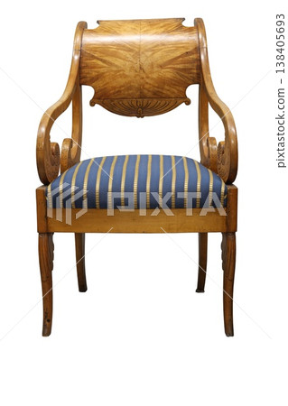 Beautiful vintage chair with elegant design and blue striped upholstery, showcasing craftsmanship from a bygone era Beautiful vintage chair with elegant design and blue striped upholstery, showcasing craftsmanship from a bygone era 138405693