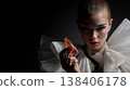 Avant-Garde High Fashion Model with Dramatic Eye Makeup Holding Prosciutto 138406178