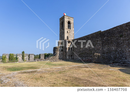 Medieval belfry and surviving defensive wall stand in the castle ruins of Cavriana 138407708