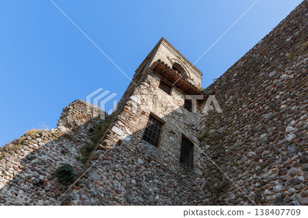 Medieval bell tower and inner castle walls in Cavriana rise with rugged stone textures 138407709