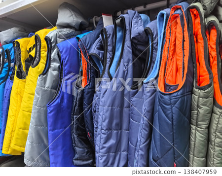 Colorful collection of stylish vests arranged neatly on clothing rack Colorful collection of stylish vests arranged neatly on clothing rack 138407959