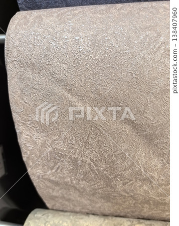 Beautiful textured wallpaper rolls on display in a design showroom 138407960