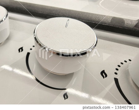 Elegant knobs on a modern kitchen stove invite culinary adventures 138407961