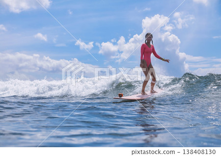Female Surfer On Longboard Under Tropical Blue Sky By Peaceful Horizon Female Surfer On Longboard Under Tropical Blue Sky By Peaceful Horizon 138408130