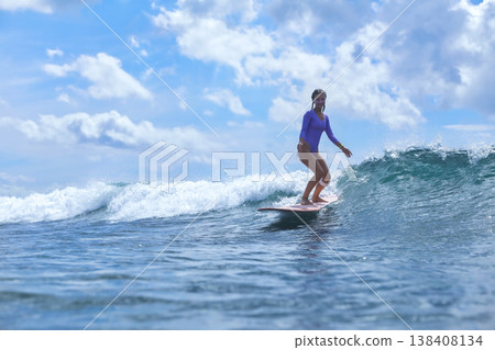 Selfassured Female Effortlessly Rides Bright Ocean Currents Selfassured Female Effortlessly Rides Bright Ocean Currents 138408134