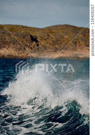 A wave of the Barents Sea breaks against a strong wind in sunny weather A wave of the Barents Sea breaks against a strong wind in sunny weather 138408267