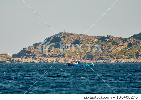 the coast of the Barents Sea, pleasure boats in the sea, the rocky shore with colourful arctic carpet of moss, yagel, Tundra at autumn the coast of the Barents Sea, pleasure boats in the sea, the rocky shore with colourful arctic carpet of moss, yagel, Tundra at autumn 138408270