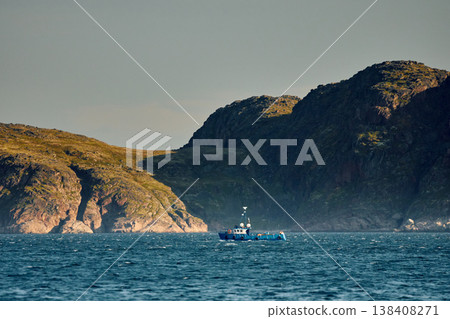 the coast of the Barents Sea, pleasure boats in the sea, the rocky shore with colourful arctic carpet of moss, yagel, Tundra at autumn 138408271