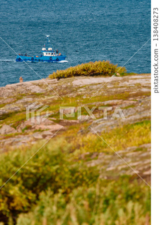 pleasure boats in the sea, the coast of the Barents Sea, Russia, the rocky shore with colourful arctic carpet of moss, yagel, Tundra at autumn, Murmansk region pleasure boats in the sea, the coast of the Barents Sea, Russia, the rocky shore with colourful arctic carpet of moss, yagel, Tundra at autumn, Murmansk region 138408273