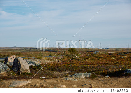 A field with windmills, turbine, extraction of clean electricity, colourful arctic carpet of moss, yagel, sunset, Tundra at autumn, tundra near the town of Teriberka in Russia, Murmansk region A field with windmills, turbine, extraction of clean electricity, colourful arctic carpet of moss, yagel, sunset, Tundra at autumn, tundra near the town of Teriberka in Russia, Murmansk region 138408280