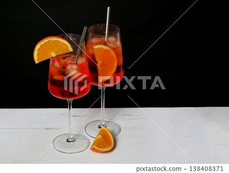 Aperol Spritz Cocktails with Orange Garnish on Black Background Aperol Spritz Cocktails with Orange Garnish on Black Background 138408371