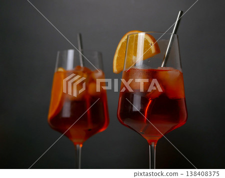 Two Aperol spritz cocktails with orange slice and ice. 138408375