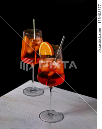 Aperol Spritz Cocktails with Orange Garnish on Black Background Aperol Spritz Cocktails with Orange Garnish on Black Background 138408377