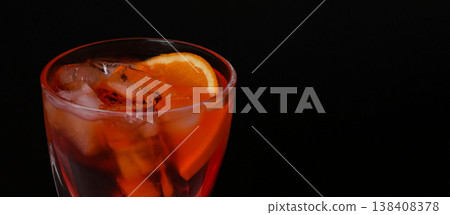 Aperol spritz cocktail with ice and orange slice in a stylish glass on a dark background. Summer drink, bar concept, vibrant color, luxury lifestyle Aperol spritz cocktail with ice and orange slice in a stylish glass on a dark background. Summer drink, bar concept, vibrant color, luxury lifestyle 138408378