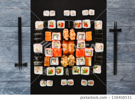 Japanese food restaurant delivery - sushi maki, unagi, gunkan and roll big party platter set on blue wood background, above view Japanese food restaurant delivery - sushi maki, unagi, gunkan and roll big party platter set on blue wood background, above view 138408531