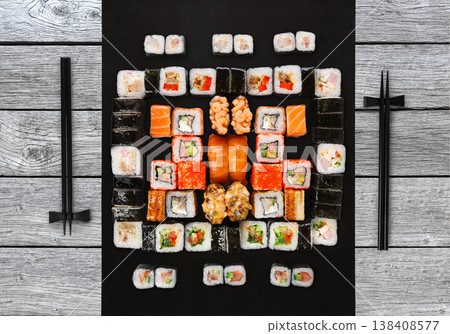 Japanese food restaurant delivery - sushi maki, unagi, gunkan and roll big party platter set on gray wood background, above view Japanese food restaurant delivery - sushi maki, unagi, gunkan and roll big party platter set on gray wood background, above view 138408577