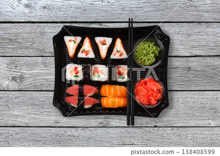 Japanese food delivery. Set of sushi and rolls top view on gray wood 138408599