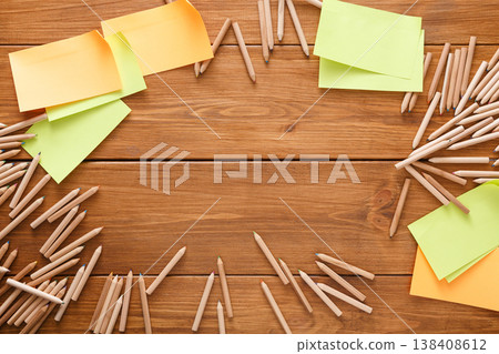 Stationery - top view of blank yellow sticky and memo notes and color pencils making frame with copy space on wooden table background, nobody, objects Stationery - top view of blank yellow sticky and memo notes and color pencils making frame with copy space on wooden table background, nobody, objects 138408612